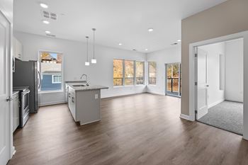A spacious kitchen with a refrigerator, sink, and cabinets. at The Lumos Apartments, Ohio, 44106